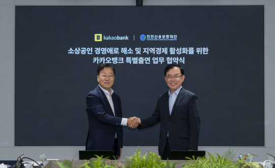 윤호영(왼쪽) 카카오뱅크 대표와 전무수 인천신용보증재단 이사장이 지난 24일 카카오뱅크 판교오피스에서 진행된 '인천시 창업기업 상생보증 업무협약' 체결식에서 기념 촬영을 하고 있다. 카카오뱅크 제공.